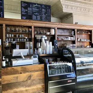 a coffee shop counter with a variety of items