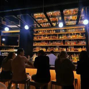 Beautiful bar area, every detail is so gorgeous! Mirrors and lighting above, the bar itself, the barstools! In love with it all.