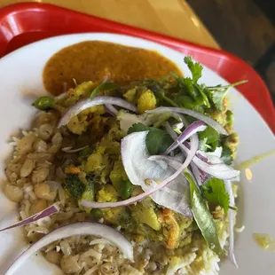 Basmati rice bowl with mixed veggies with yellow lentil sauce.