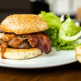 a burger with bacon and lettuce