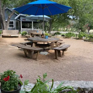 a picnic table with a blue umbrella