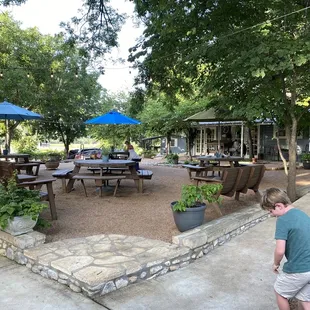 a patio with tables and umbrellas