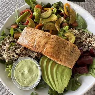Salmon on top of the grain bowl.