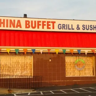a red building with a sign that says china buffet grill and sushi