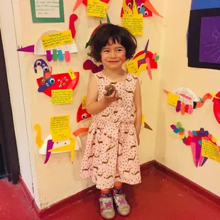 One of our students proudly standing by her work.