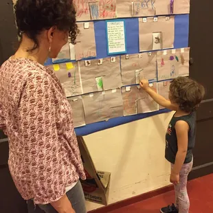 Student proudly sharing work with her mom.