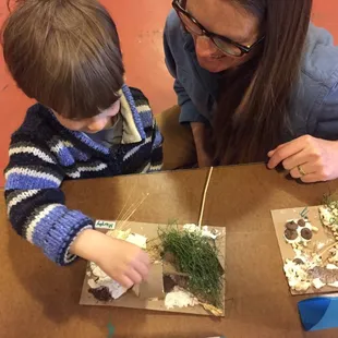 Student sharing his work with his mother.
