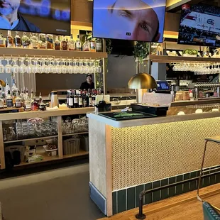 a bar with a television and a bar counter