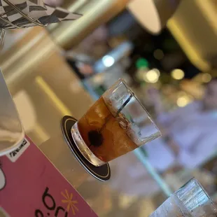 a glass of iced coffee on a table