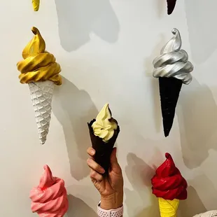 a person holding a cone of ice cream