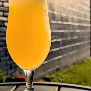 Large tulip glass featuring shandy style beer, Sun Showers.