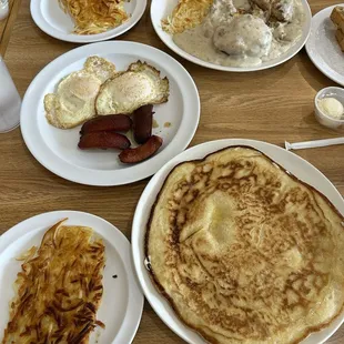 Pancake, hash browns, fried eggs with sausage, and biscuits and gravy.