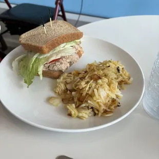 Tuna salad sandwich with hash browns.