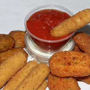 a bowl of ketchup and fried tater tots