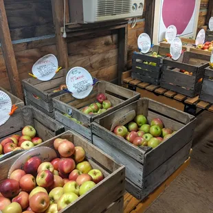a display of apples in wooden crates