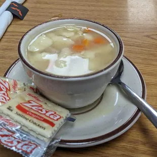 a cup of soup and crackers