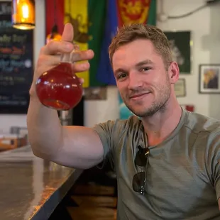  man sitting at a bar with a drink in his hand