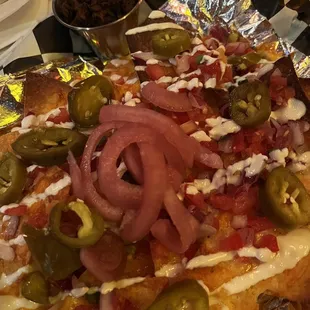 a pizza with onions and jalapenos