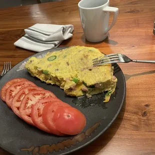 Three egg omelette and a side of tomatos
