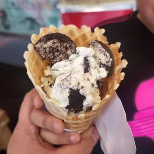 a person holding an ice cream cone