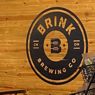 a wooden wall with a logo on it