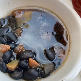 a bowl of black beans and potatoes