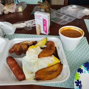 Bandeja Paisa; rice and steak are under the eggs.