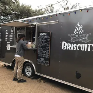 a man ordering food from a food truck