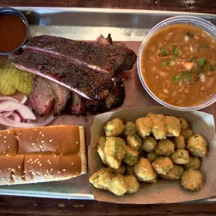 Two meat plate: sliced brisket, ribs, fried okra, and brisket beans.