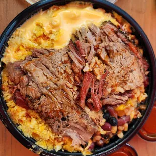 Bowl with mac and cheese base, brisket, cornbread casserole and beans.  They forgot my tater tots!