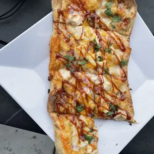 Partially eaten BBQ Chicken Pizza