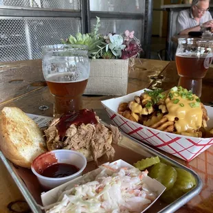BBQ Pork sandwich, cole slaw, dill pickles and a side of fries.