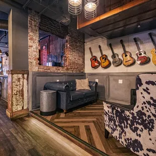 a living room with guitars on the wall