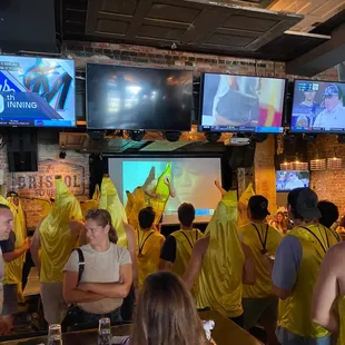a large group of people watching televisions