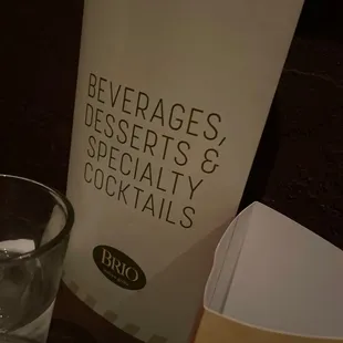 a glass of water and a menu