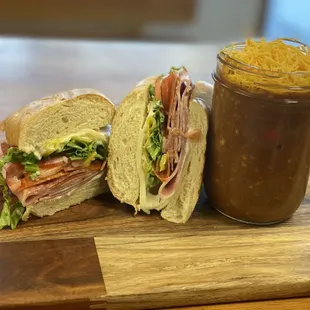 Our delicious deli grinder sandwich with a jar of our housemade chili!