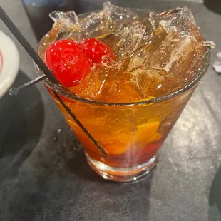 a drink with ice and cherries