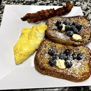 a plate of french toast and eggs