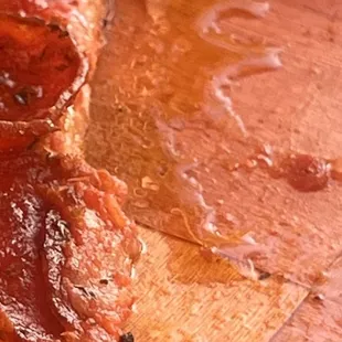 12" Medium Britt's Pizza sitting in mound of grease