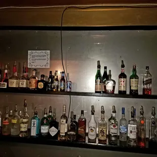 a shelf full of alcohol bottles