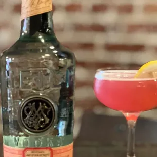 a bottle of gin and a cocktail