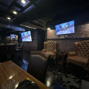 a bar with couches and televisions