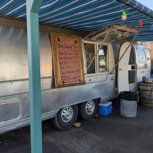 a food truck parked under a awning