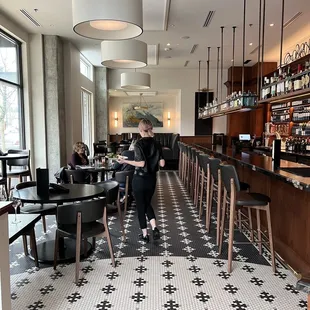 a woman walking through the bar