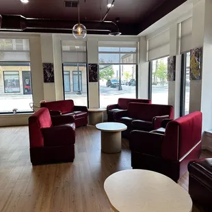a living room with red couches