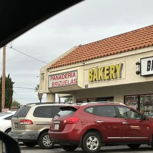 cars parked in front of a bakery