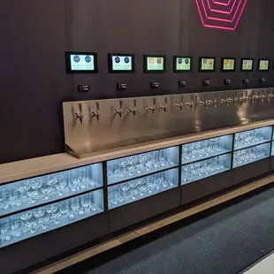 a row of beer taps on a counter