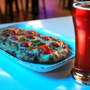 a pizza and a glass of beer