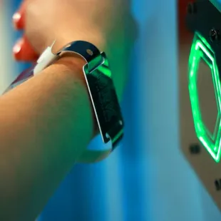 a person&apos;s wrist with a green light on it