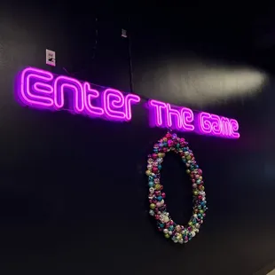 a neon sign that says enter the zone